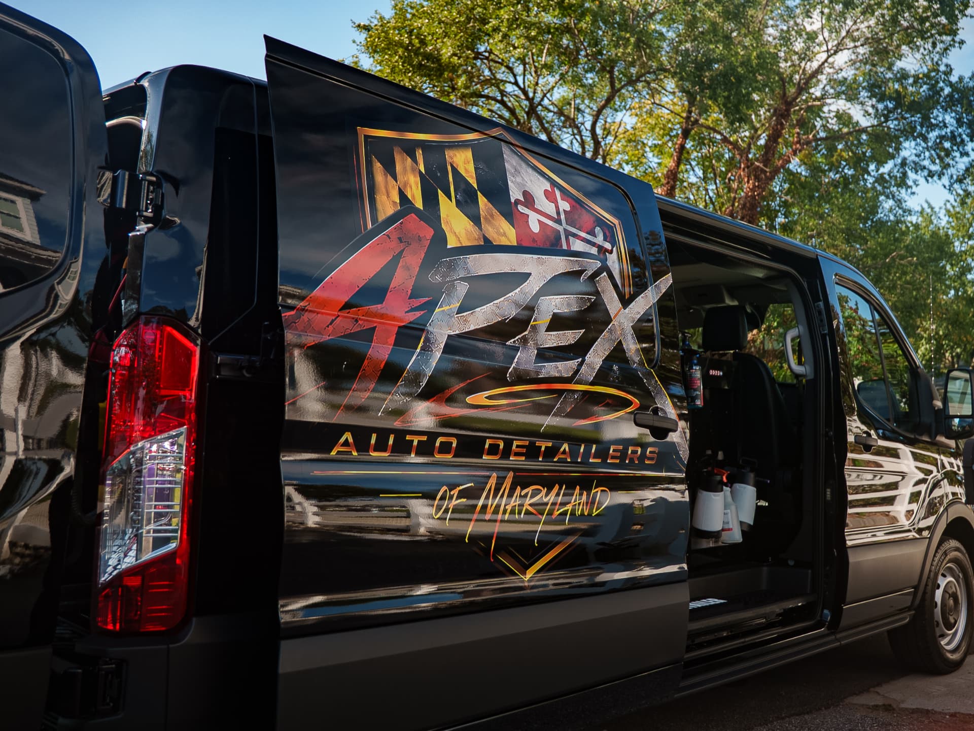 Apex mobile detailing van with side door open showing onboard equipment